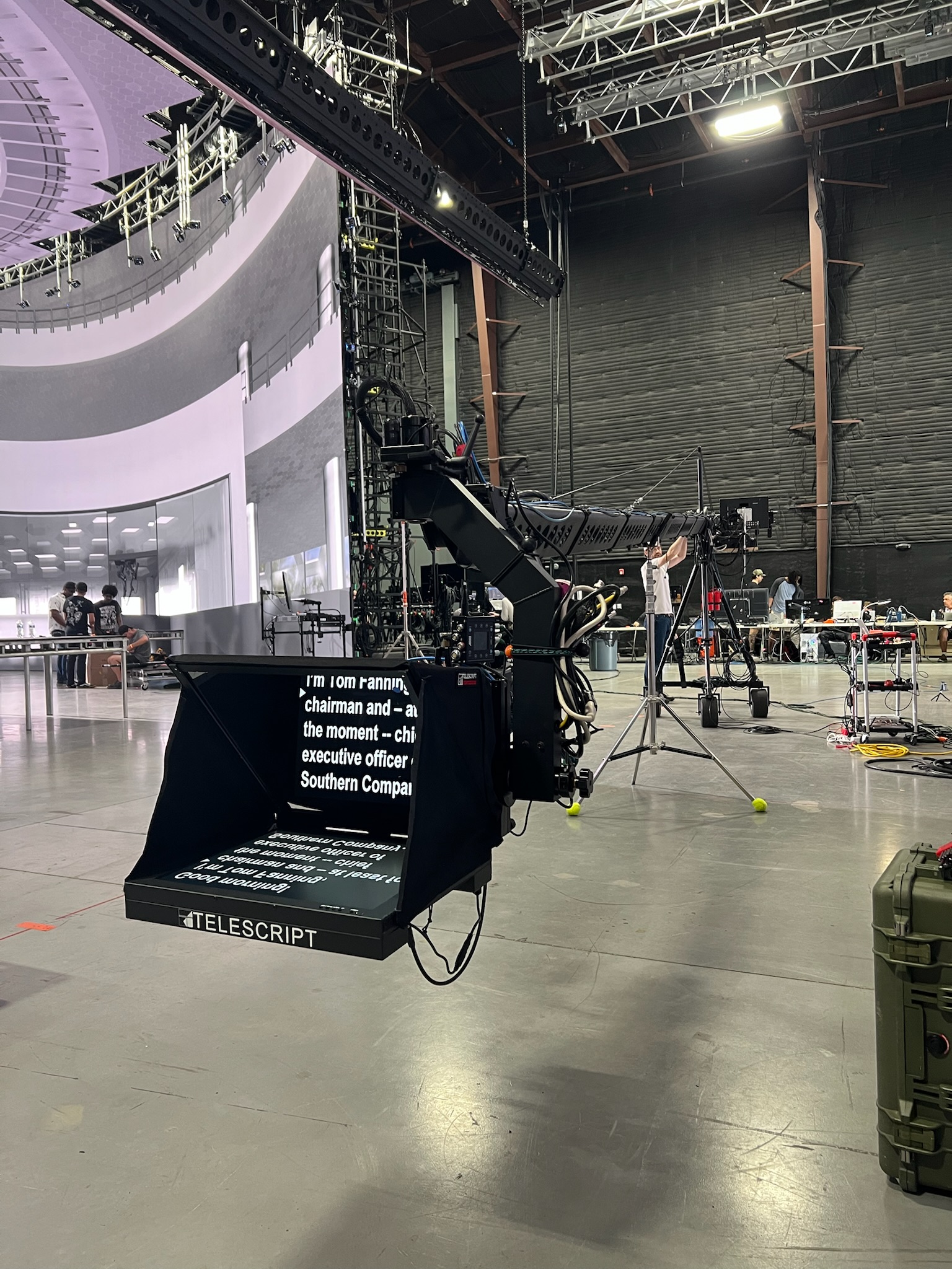 Large jib-mounted teleprompter rig on a corporate soundstage production