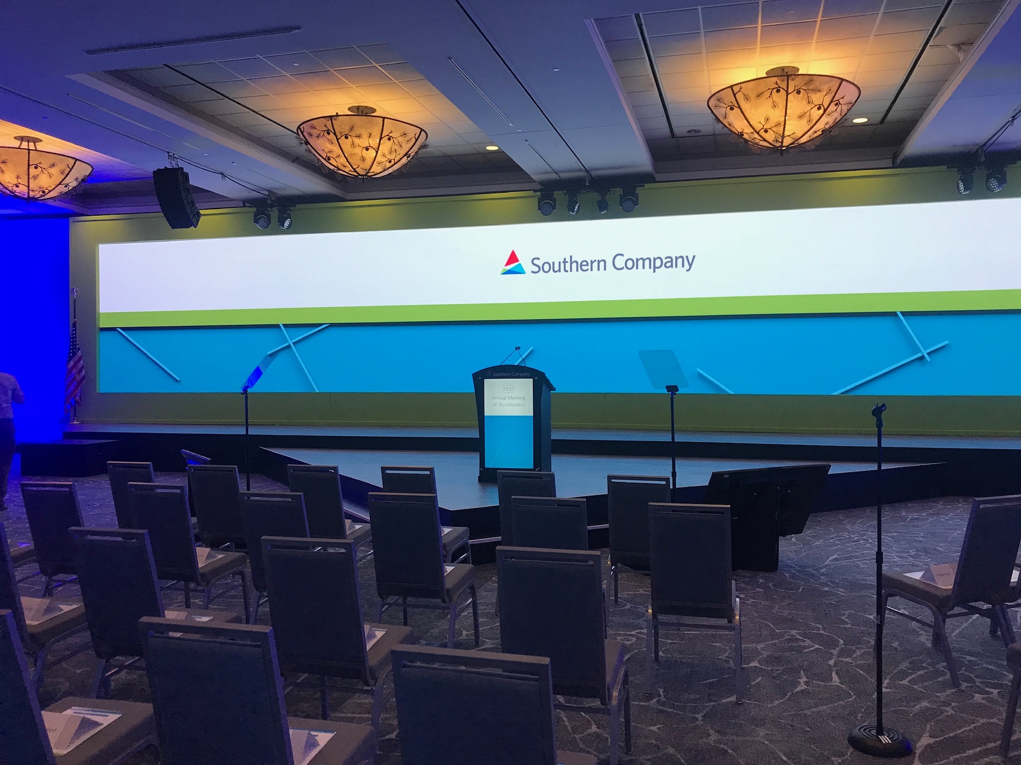 Southern Company annual meeting stage with branded backdrop, podium, and teleprompter glass